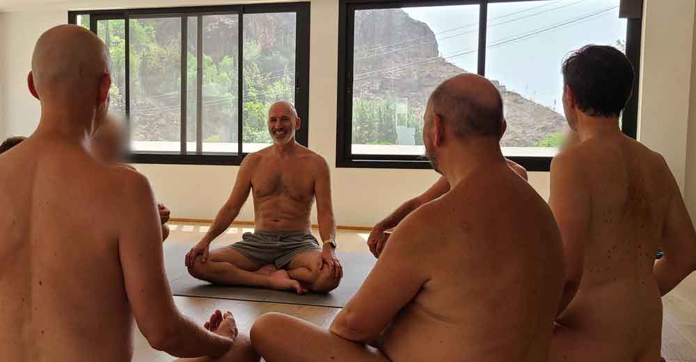 Men sitting together in a clothing-optional retreat circle in the Aya House studio